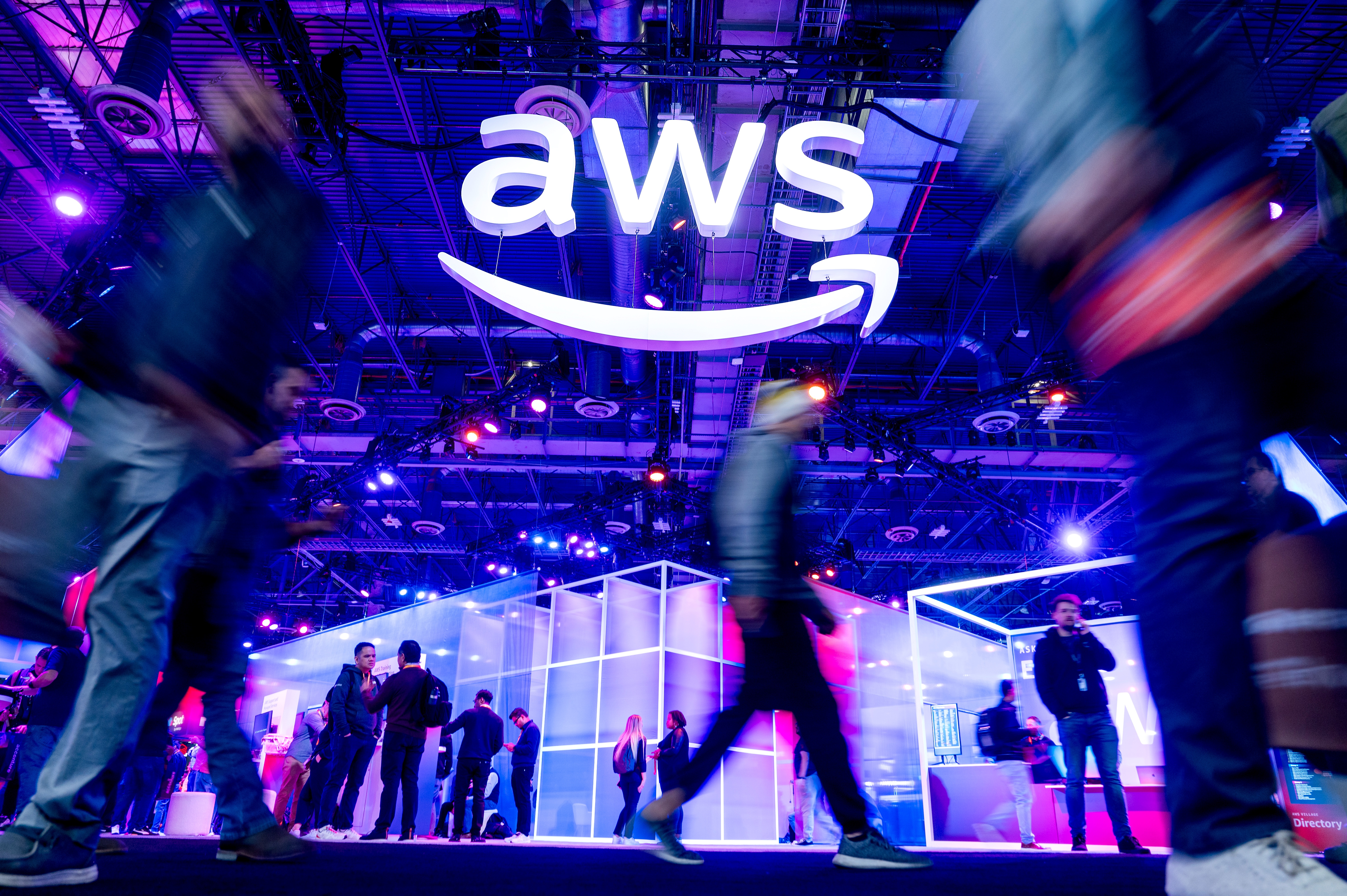 Attendees walk through an expo hall at a conference hosted by Amazon Web Services at The Venetian Las Vegas on Nov. 28, 2023, in Las Vegas. AWS is responsible for infrastructure supporting websites across the internet.